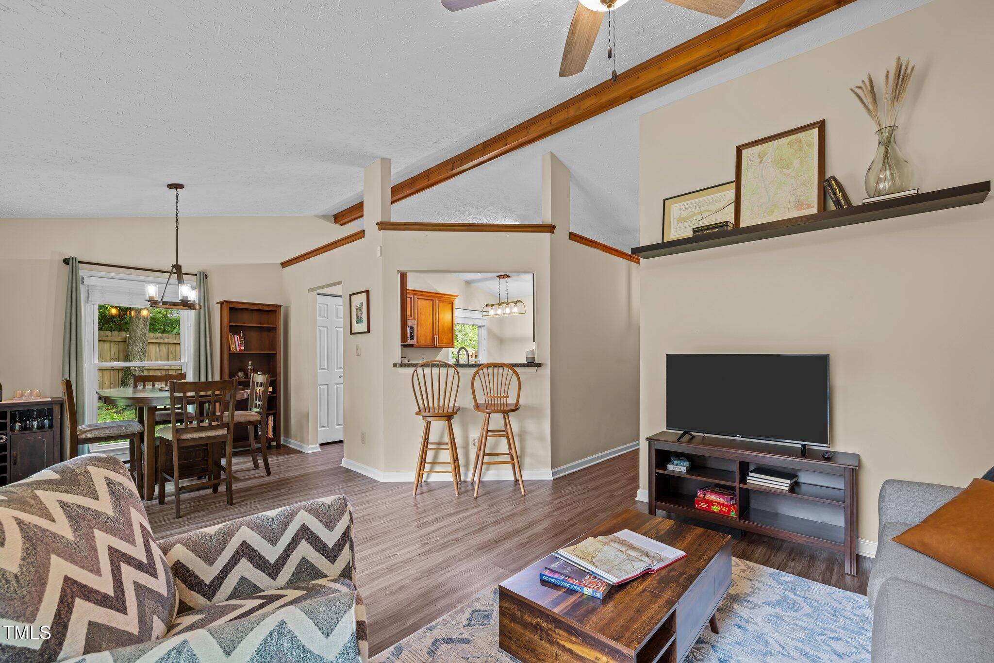 5801 Hadrian Drive Durham, NC 27703 - Photo 3 of 40 a living room with furniture and a flat screen tv