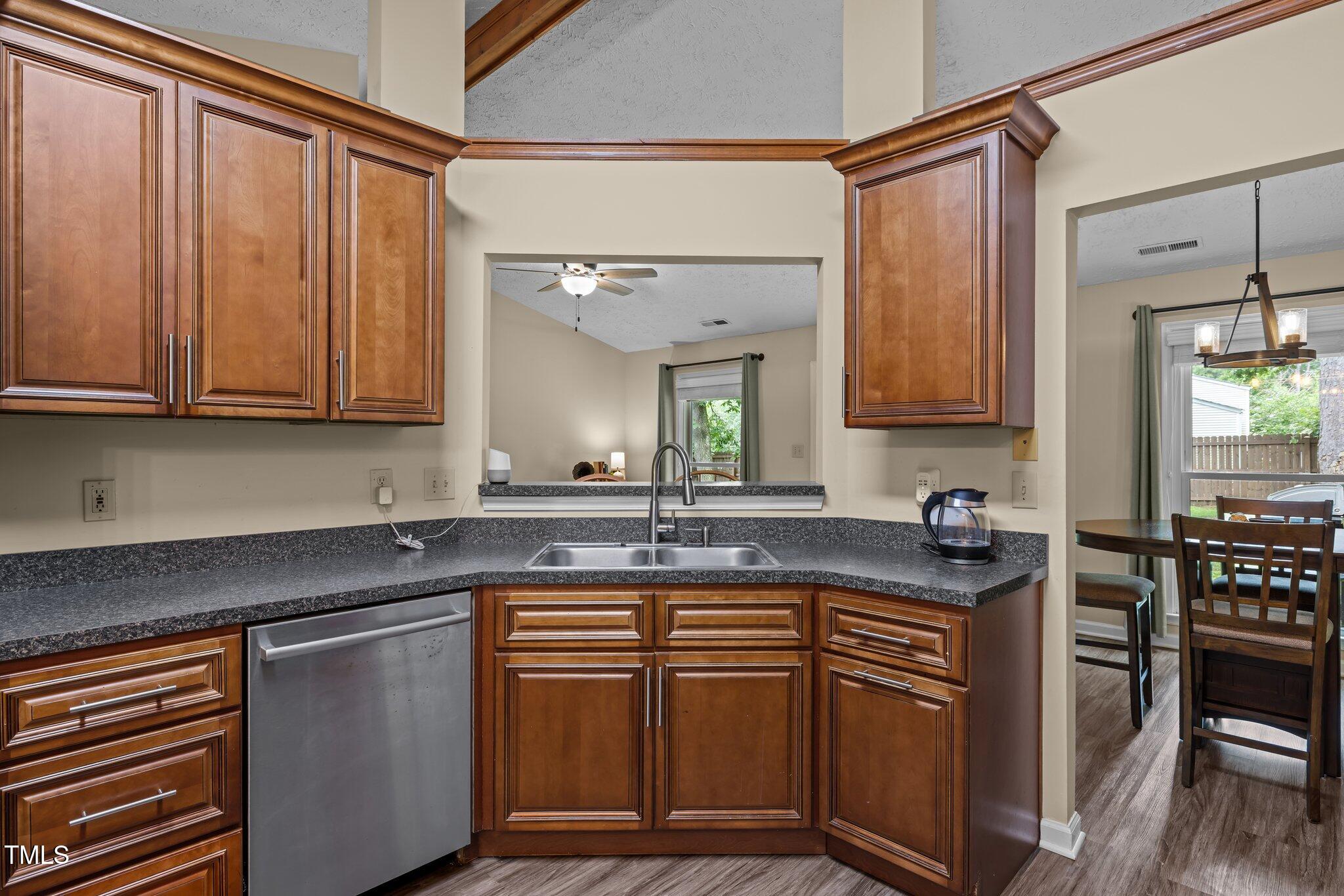 5801 Hadrian Drive Durham, NC 27703 - Photo 8 of 40 a kitchen with stainless steel appliances granite countertop a sink stove and cabinets