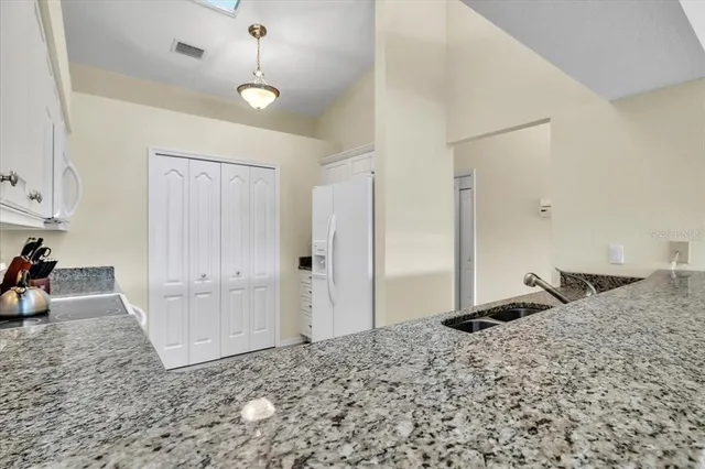 a bedroom with a large bed and a flat tv screen on dresser