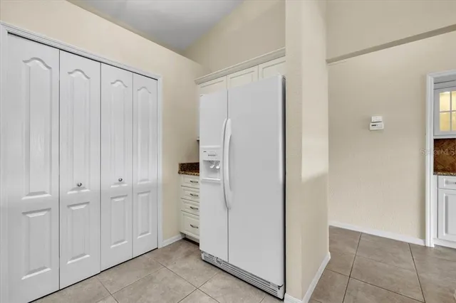 a spacious bathroom with a granite countertop sink a mirror and a bathtub