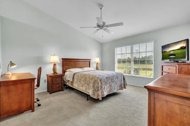 a bedroom with a bed chandelier and a window
