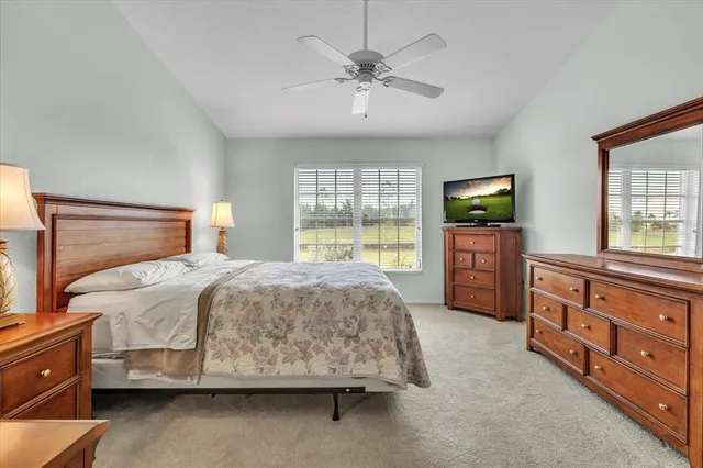 a bedroom with a bed and a ceiling fan