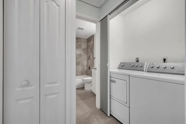 an aerial view of a house with a yard and lake view