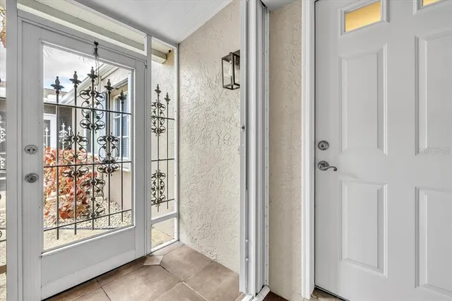 a dining room with furniture and a large window