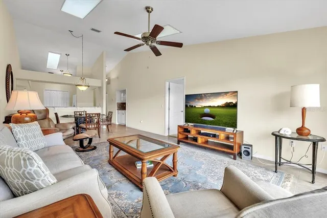a view of a bedroom with wooden floor and ceiling fan