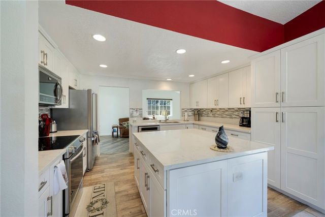 a kitchen with a sink a stove and cabinets