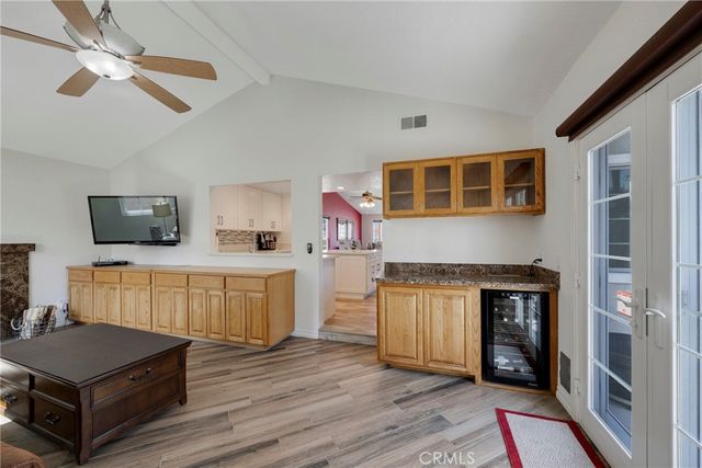 a kitchen with a refrigerator and a wooden cabinets
