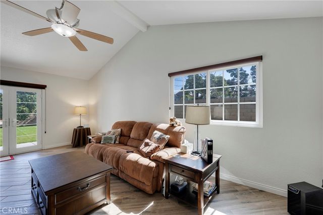 a living room with furniture a window and a chandelier