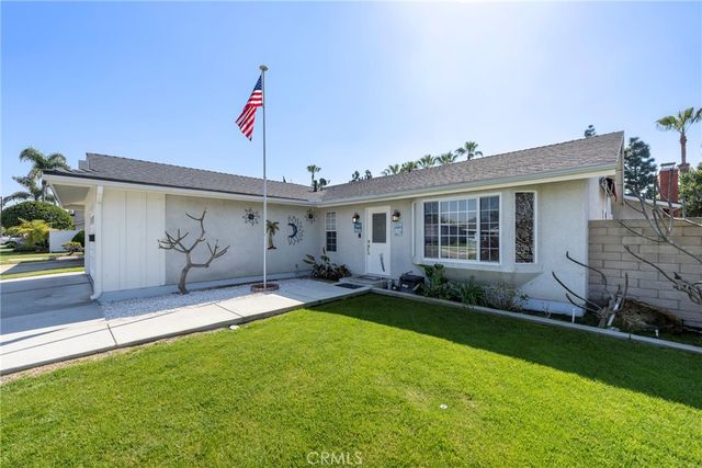 a view of a house with a yard and a patio