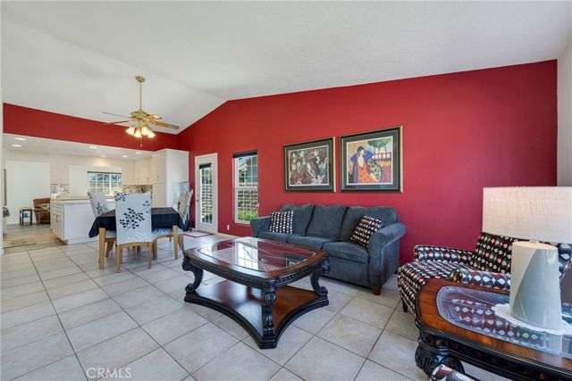 a living room with furniture a chandelier and a rug