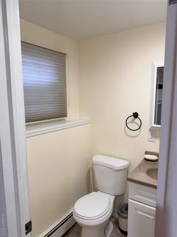 a white toilet sitting next to a bathroom sink