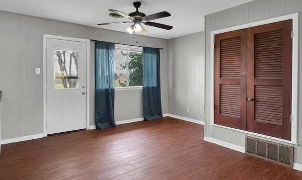 wooden floor in an empty room with a window