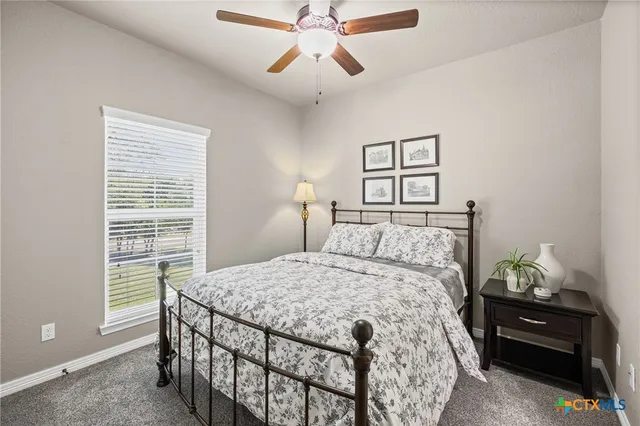 a bedroom with a bed and a lamp