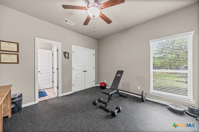 a view of a livingroom with furniture and a ceiling fan
