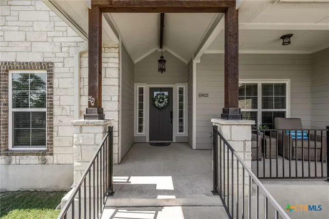 a view of backyard with furniture and a potted plant