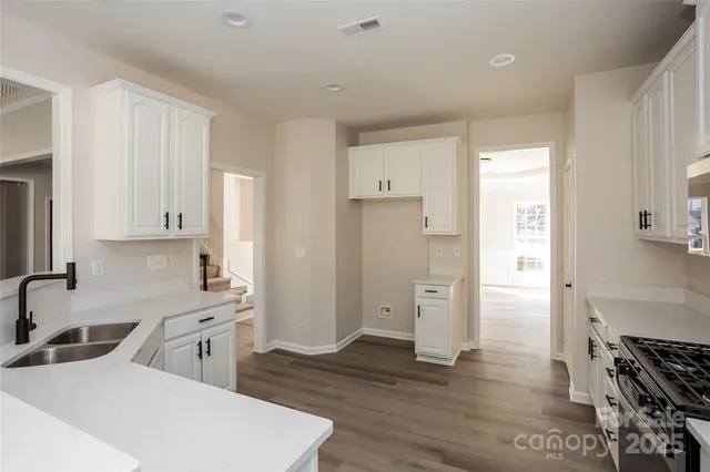 a kitchen with stainless steel appliances a refrigerator sink and cabinets