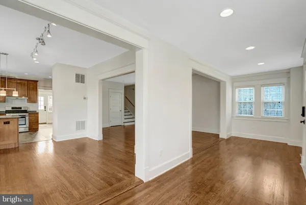 a view of a kitchen with wooden floor and a kitchen