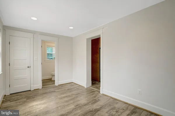 a bathroom with a granite countertop toilet sink and mirror