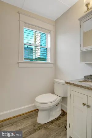 a white toilet sitting next to a bathroom sink