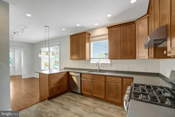 a kitchen with stainless steel appliances granite countertop a sink stove and cabinets