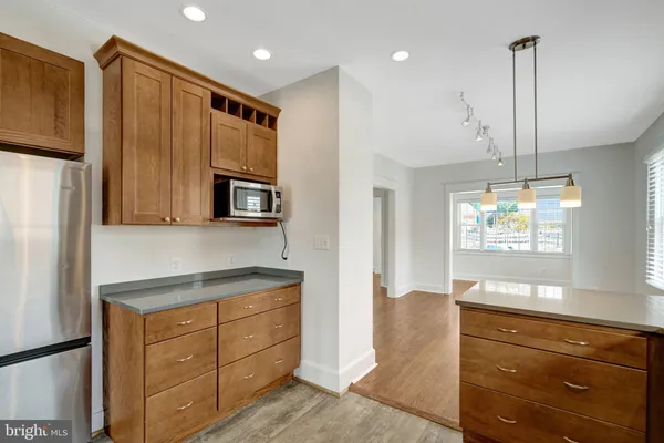 a kitchen with a refrigerator and a sink