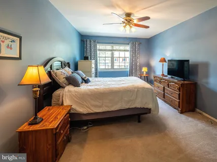 a bedroom with bed and window