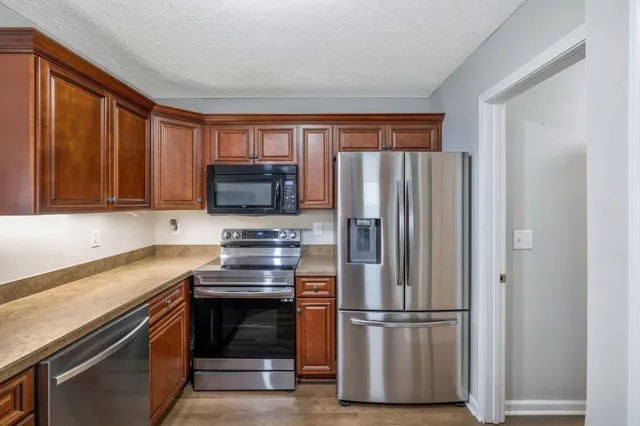 a kitchen with a refrigerator stove and microwave