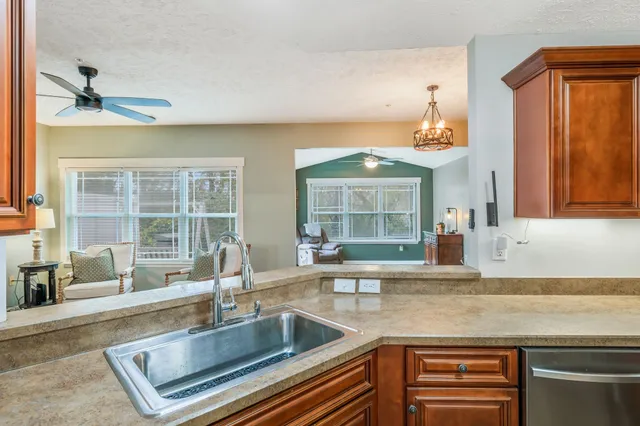 a kitchen with sink and a window