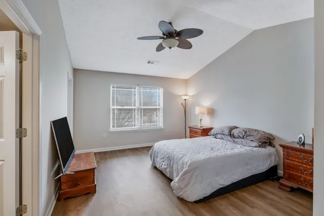 a bedroom with a bed a couch and a window