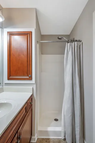 a bathroom with a shower and a sink
