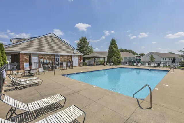 a view of a house with swimming pool and sitting area