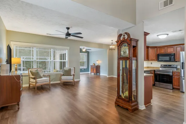 a living room with furniture and a wooden floor