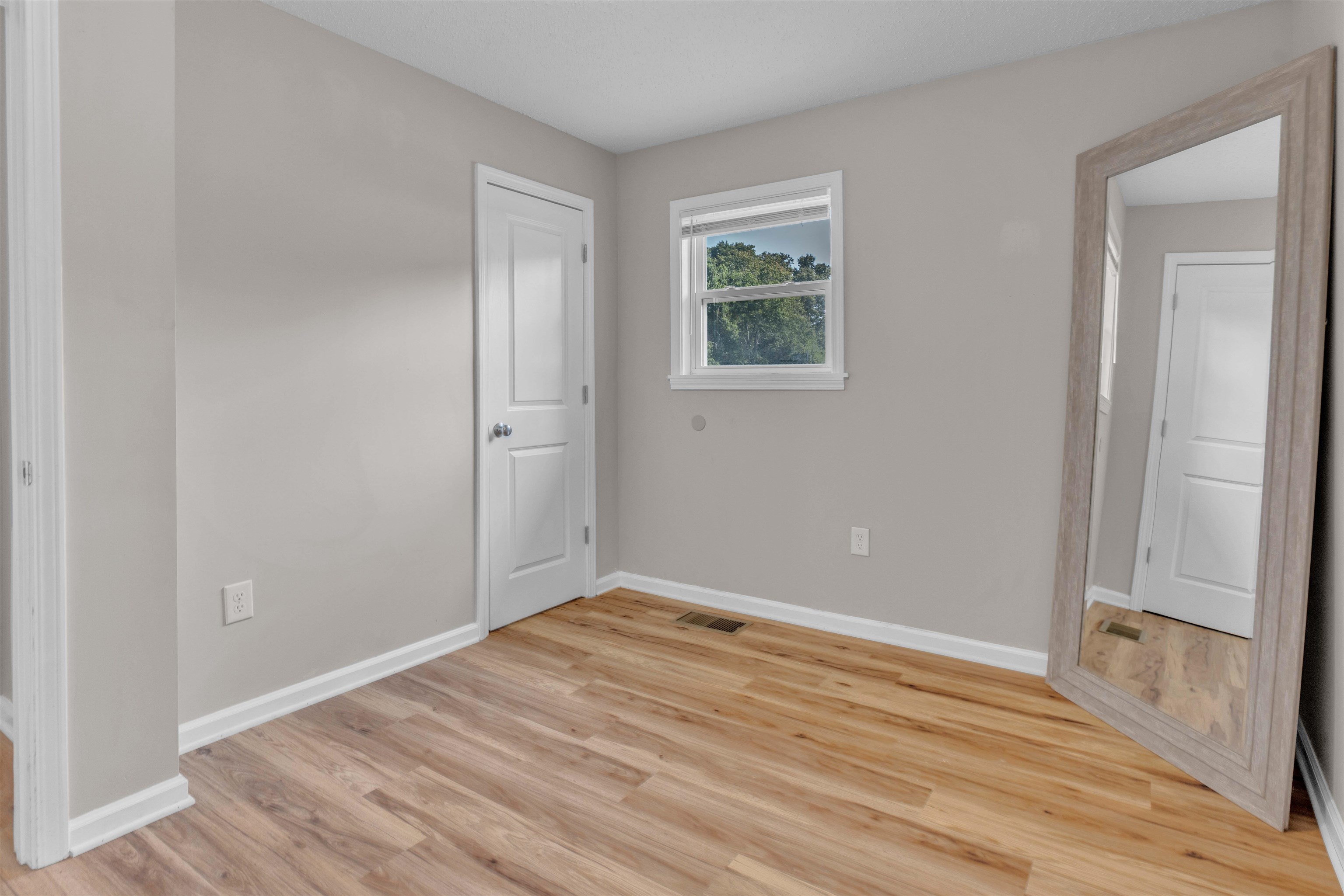 185 Henry Road Somerville, TN 38068 - Photo 18 of 21 Wood-finish flooring with light gray wall paint and white trim