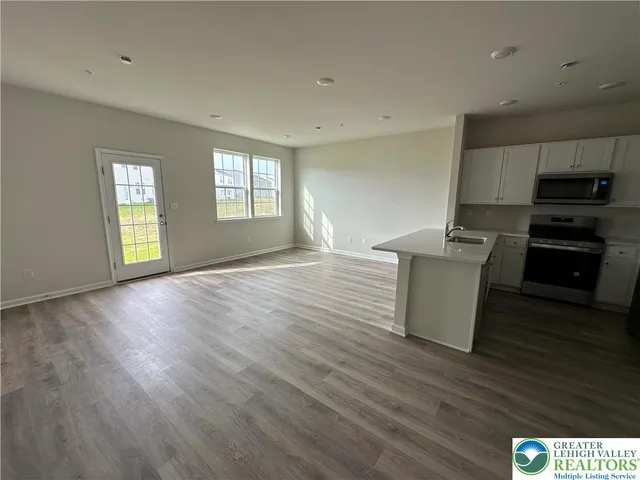 a view of kitchen with microwave and cabinets
