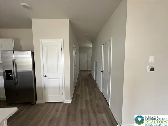 a view of hallway with wooden floor