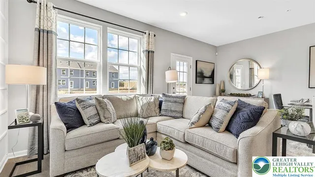 a living room with furniture and a large window