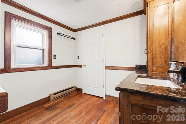 a view of a room with wooden floor and cabinet