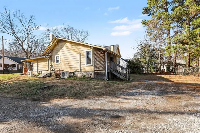 a view of large yard with road and trees
