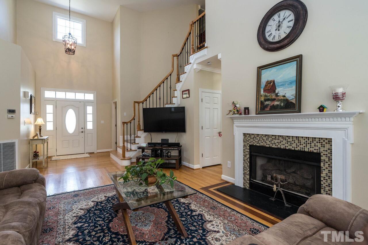 2017 Vintners Court Raleigh, NC 27610 - Photo 8 of 39 a living room with furniture a flat screen tv and a fireplace