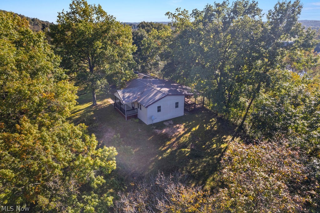 58 Rock Ridge Road Mineral Wells, WV 26150 - Photo 23 of 38 Single-story structure with a metal roof and light-colored siding, surrounded by mature trees
