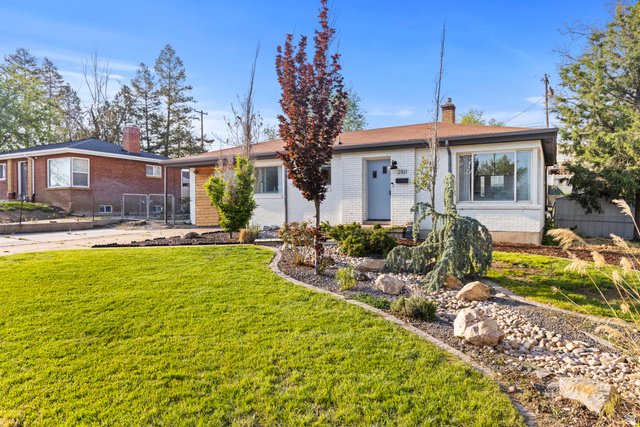 2101 West 3900th Street South Roy, UT 84067 - Photo 2 of 36 Ranch-style residence featuring a white brick facade and a light blue front door