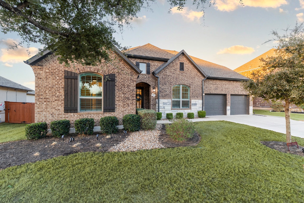 292 Axis Loop Georgetown, TX 78628 - Photo 1 of 32 a front view of a house with a yard and garage