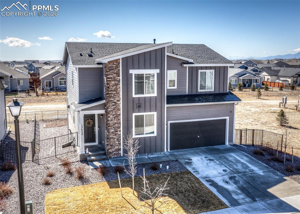 12653 Granite Ridge Drive Peyton, CO 80831 - Photo 1 of 50 a front view of a house with yard and parking