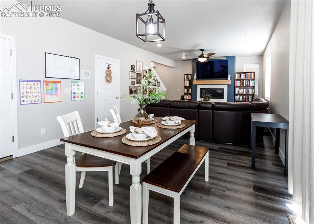 12653 Granite Ridge Drive Peyton, CO 80831 - Photo 12 of 50 a view of a dining room with furniture window and wooden floor