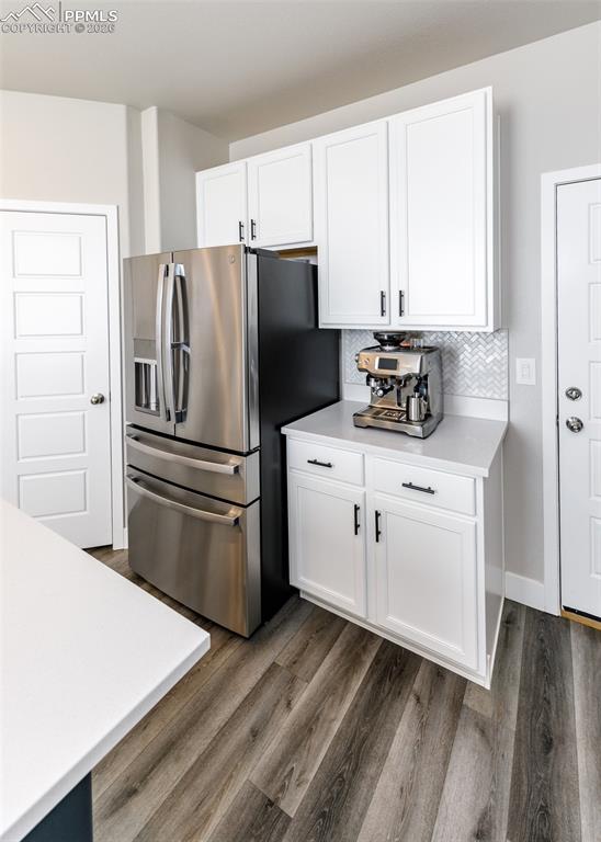 12653 Granite Ridge Drive Peyton, CO 80831 - Photo 17 of 50 a kitchen with a refrigerator sink and cabinets