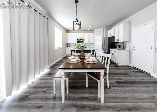 a view of a dining room with furniture window and wooden floor
