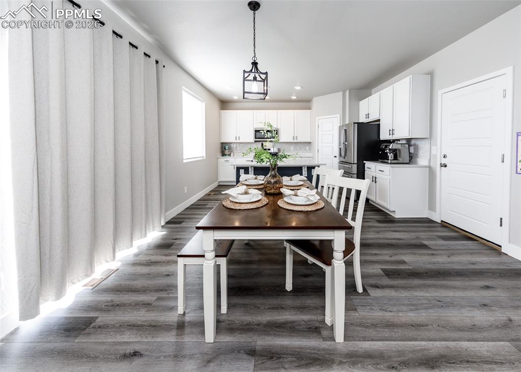 12653 Granite Ridge Drive Peyton, CO 80831 - Photo 18 of 50 a view of a dining room with furniture window and wooden floor