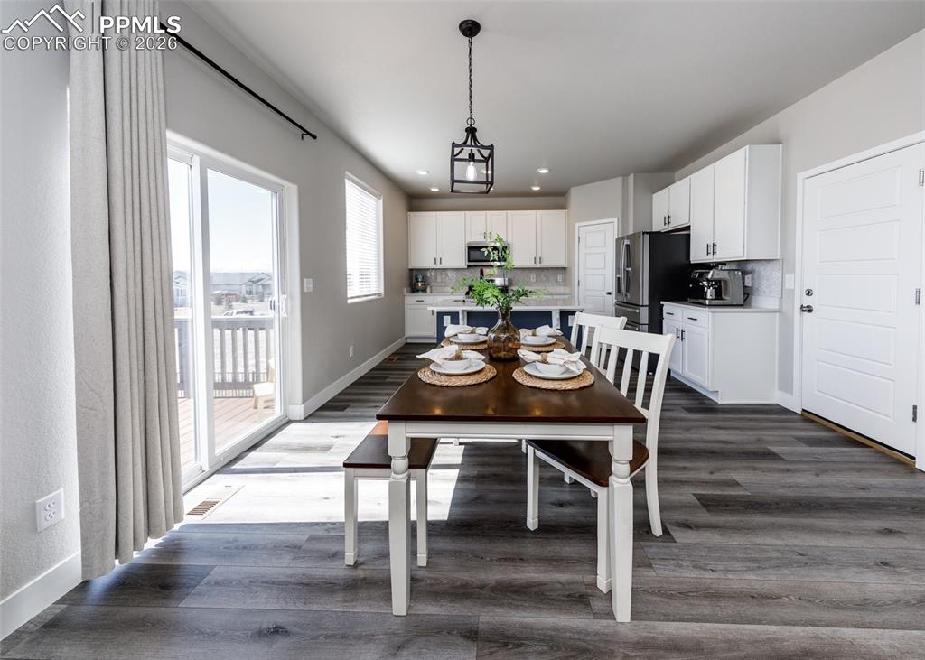 12653 Granite Ridge Drive Peyton, CO 80831 - Photo 19 of 50 a view of a dining room with furniture window and wooden floor