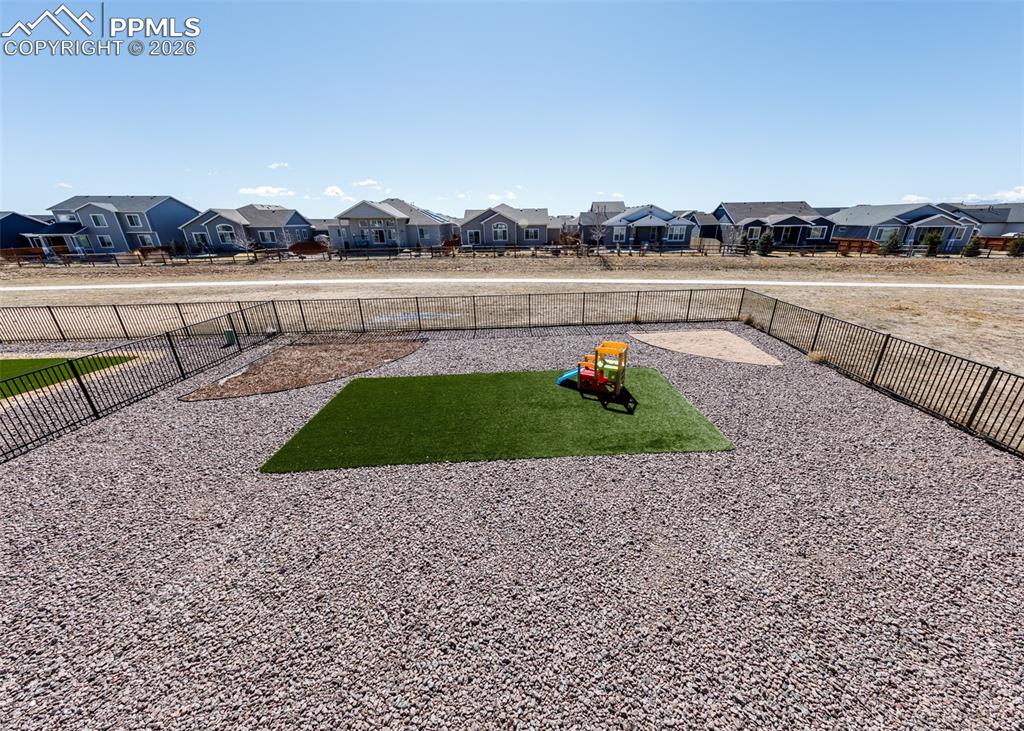 12653 Granite Ridge Drive Peyton, CO 80831 - Photo 24 of 50 a view of a lake with houses in the background