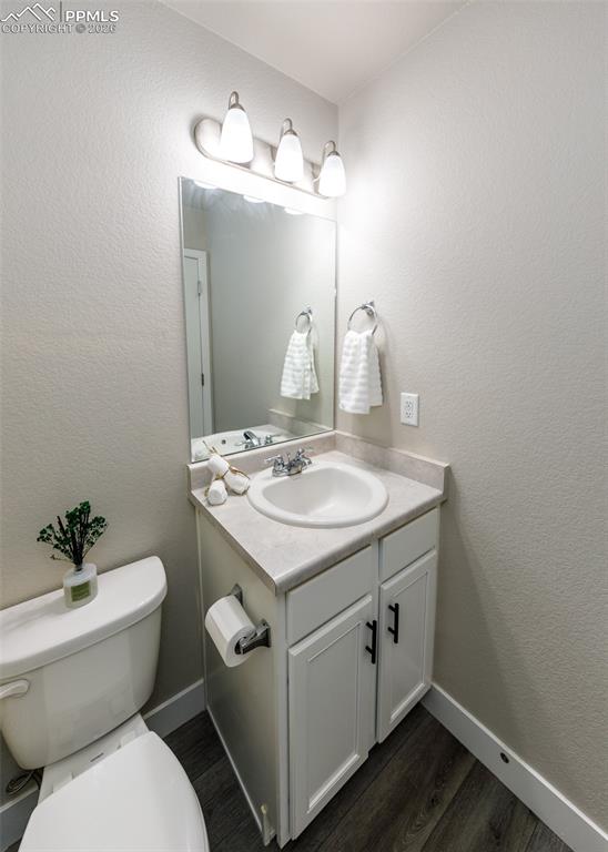 12653 Granite Ridge Drive Peyton, CO 80831 - Photo 28 of 50 a bathroom with a toilet sink and mirror
